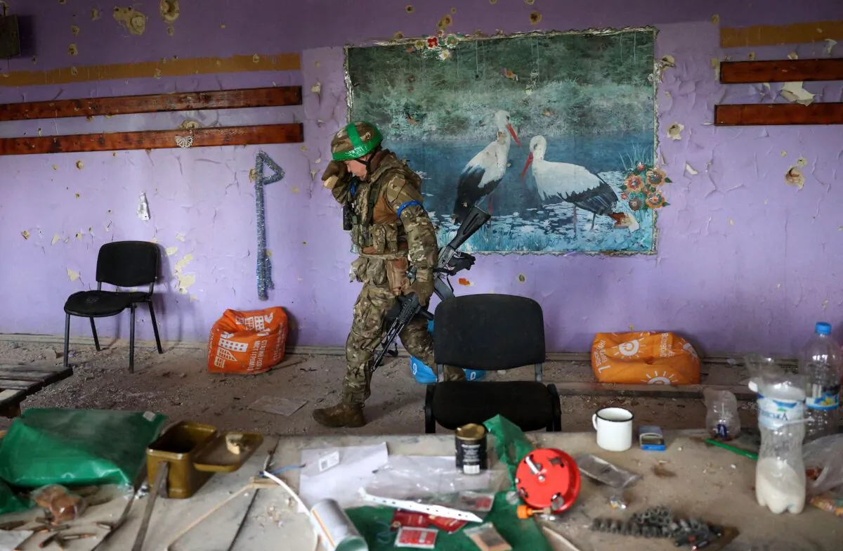 A Ukrainian serviceman walks inside a heavily damaged cultural center in the recently liberated village of Blagodatne, Donetsk region, amid the Russian invasion of Ukraine, on June 16, 2023. (Anatolii Stepanov/AFP via Getty Images)