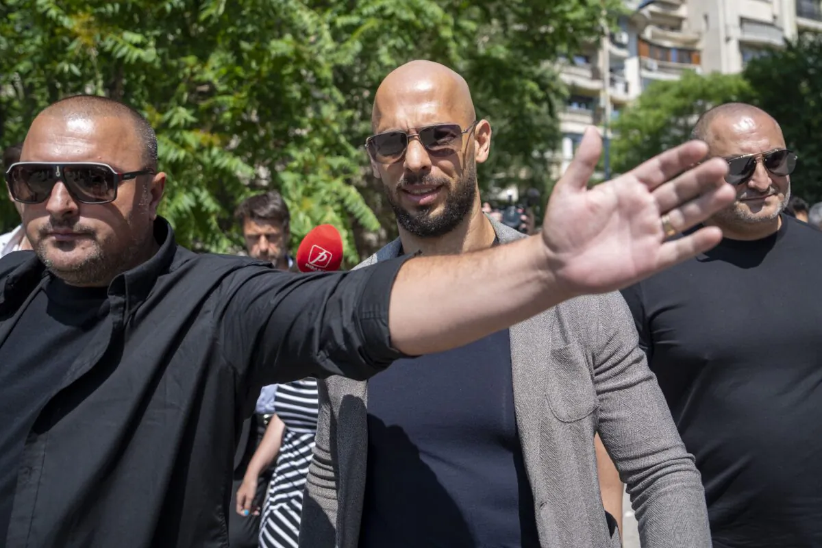 Andrew Tate walks between bodyguards as he arrives at the Bucharest Tribunal, in Bucharest, Romania, on June 21, 2023. (Vadim Ghirda/AP Photo)