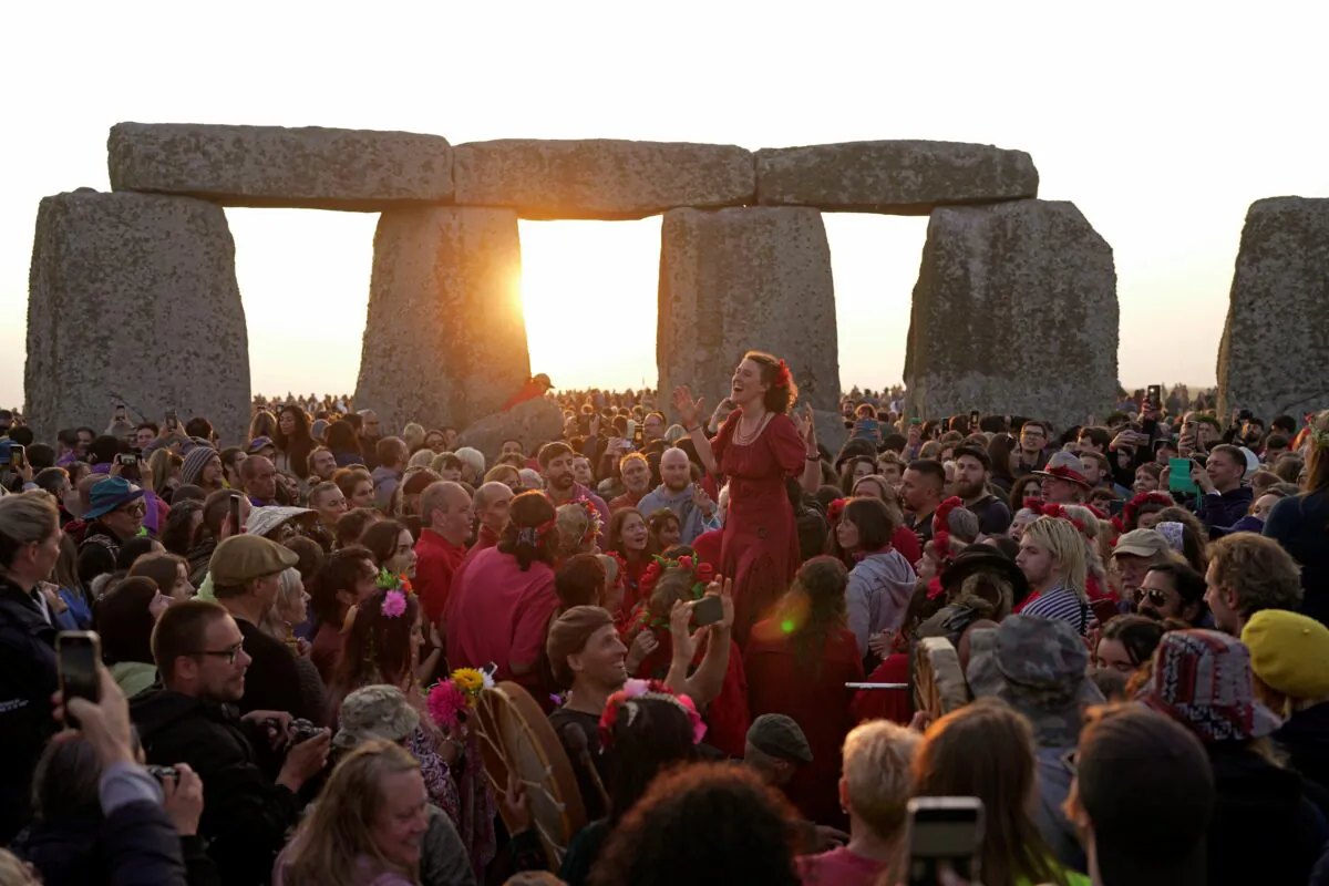 Revelers gather at the ancient stone circle Stonehenge to celebrate the Summer Solstice, the longest day of the year, near Salisbury, England, on June 21, 2023. (AP Photo/Kin Cheung)