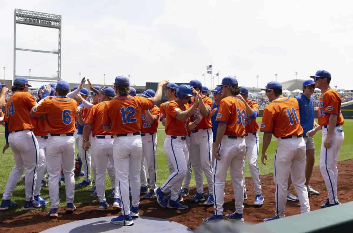 Florida players celebrate after Josh Rivera batted in Wyatt Langford, center, with a home run against TCU in the first inning of a baseball game at the NCAA College World Series in Omaha, Neb., on June 21, 2023. (Rebecca S. Gratz/AP Photo)
