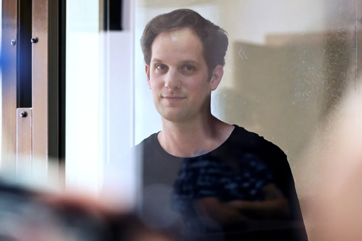 Wall Street Journal reporter Evan Gershkovich stands in a glass cage in a courtroom at the Moscow City Court in Moscow, Russia, on June 22, 2023. (Dmitry Serebryakov/AP Photo)