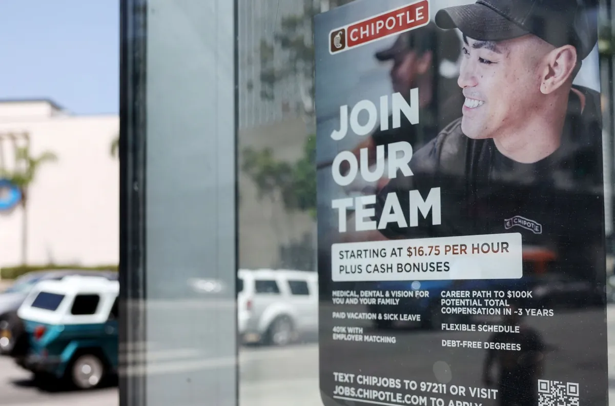 A 'Join Our Team' sign is displayed outside a Chipotle location, listing employee benefits, in Los Angeles, Calif., on June 2, 2023. (Mario Tama/Getty Images)