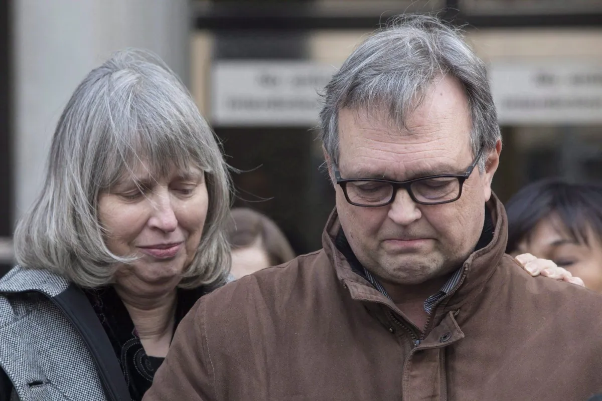 Clayton Babcock, right, stands next to his wife Linda as he reads a prepared statement outside court in Toronto on Dec. 16, 2017. (The Canadian Press/Chris Young)