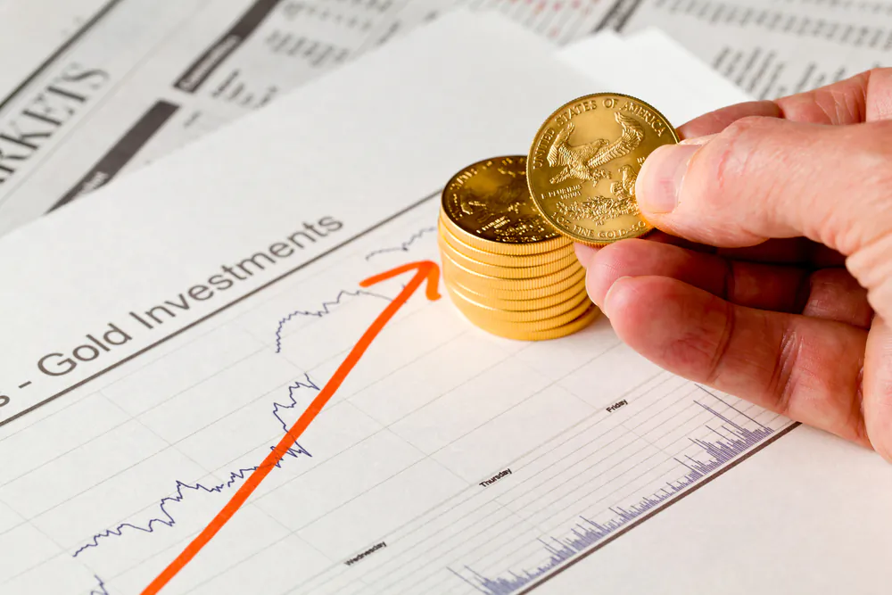 Gold Eagle one-ounce coins stacked into graph of upward gold prices. (Steve Heap/Shutterstock)