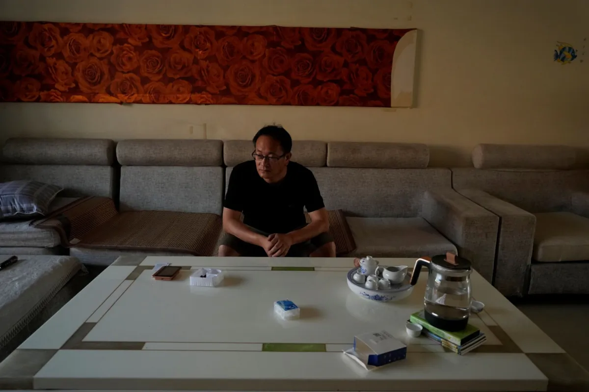 Disbarred human rights lawyer Wang Quanzhang sit in his most recent abode as he recounts the recent escalation of harassment against him, in Beijing's Changping district, on June 20, 2023. (Ng Han Guan/AP Photo)