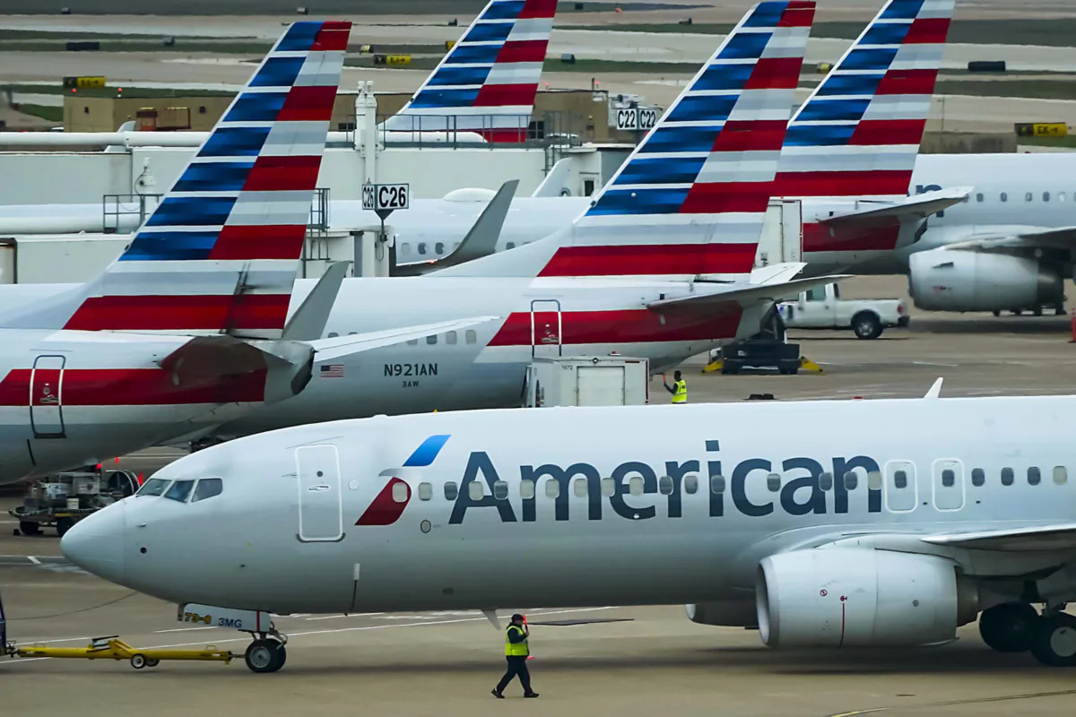An American Airlines plane pushes back from the gate at Dallas-Fort Worth International Airport terminal. (Smiley N. Pool/The Dallas Morning News/TNS)