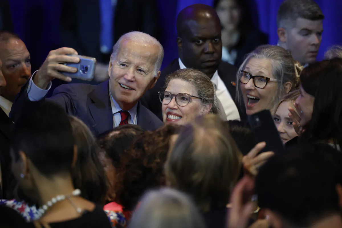President Joe Biden takes selfies with supporters during a rally on the first anniversary of the Supreme Court's Dobbs v. Jackson decision at the Mayflower Hotel on June 23, 2023 in Washington, DC. (Chip Somodevilla/Getty Images)