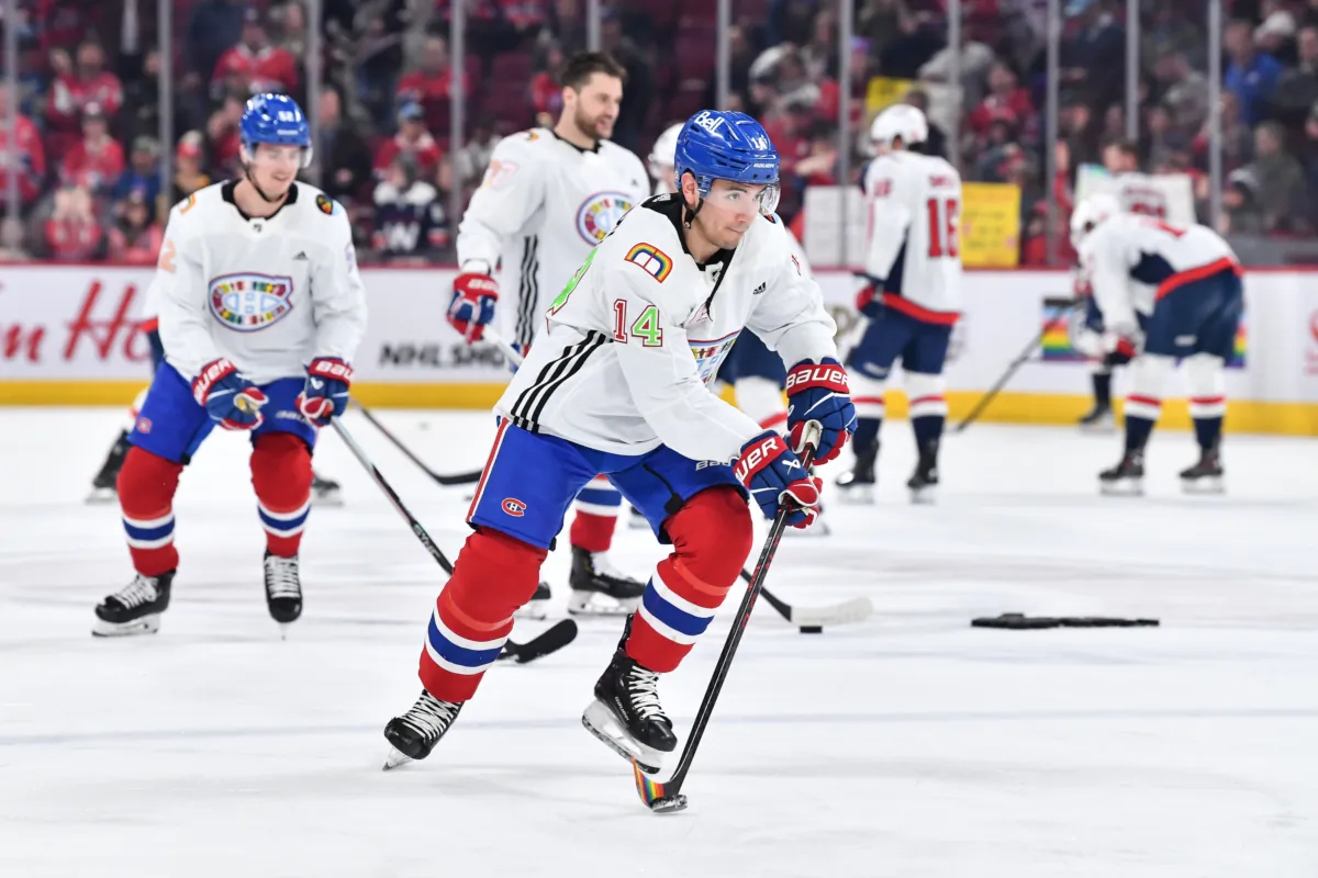 Nick Suzuki #14 of the Montreal Canadiens skates the puck as he wears a "Pride Night" jersey during warm-ups prior to the game against the Washington Capitals at Centre Bell in Montreal, Quebec, Canada, on April 6, 2023. (Minas Panagiotakis/Getty Images)