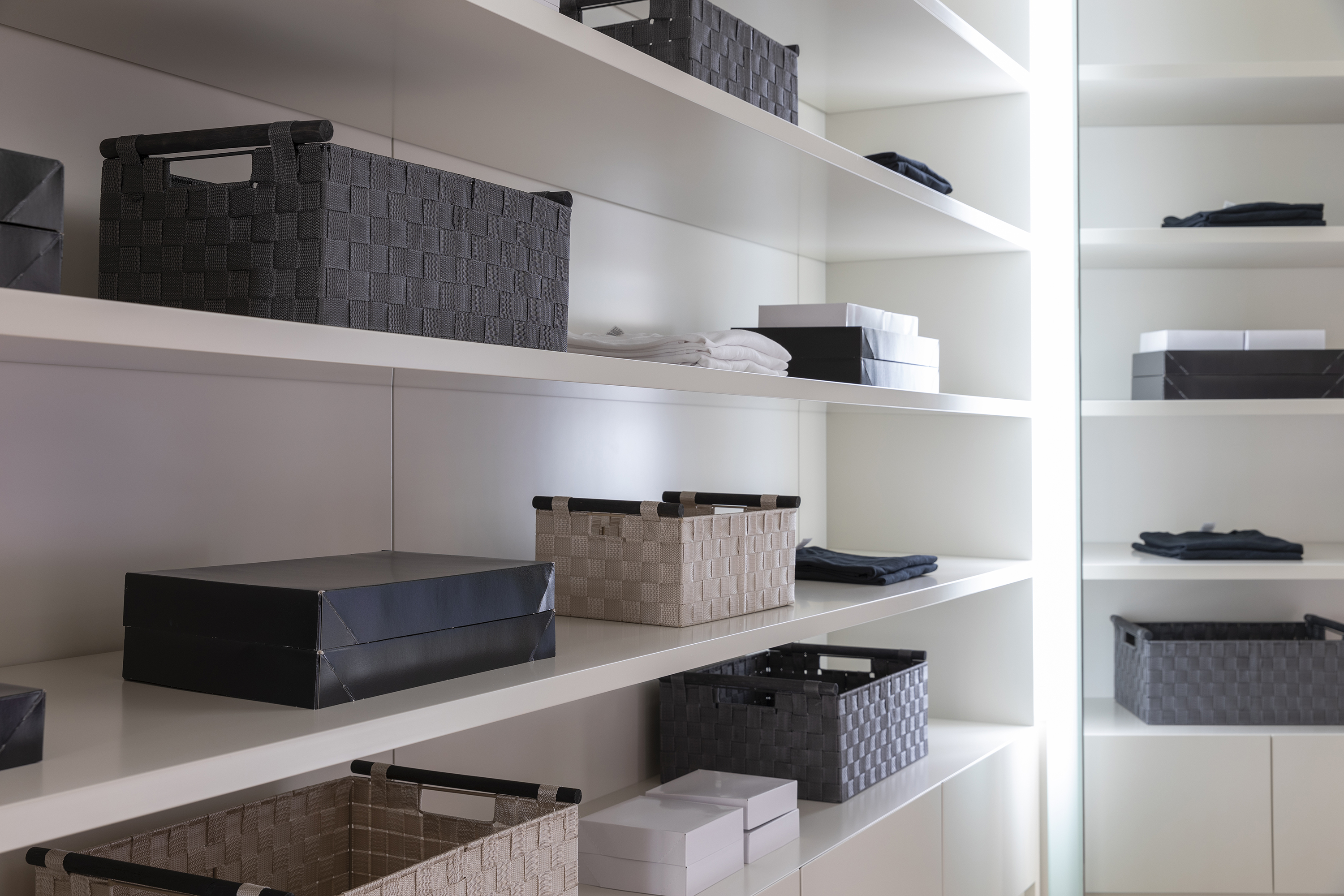 Bins and baskets help to conceal smaller closet items.