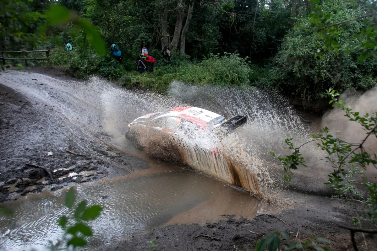 Finland's Kalle Rovanpera and co-ilot Jonne Halttunen manouvre their Toyota GR Yaris Rally1 hybrid across a stream during the third day of the World Rally Championship stage in Naivasha on June 24, 2023. (Tony Karumba/AFP via Getty Images)