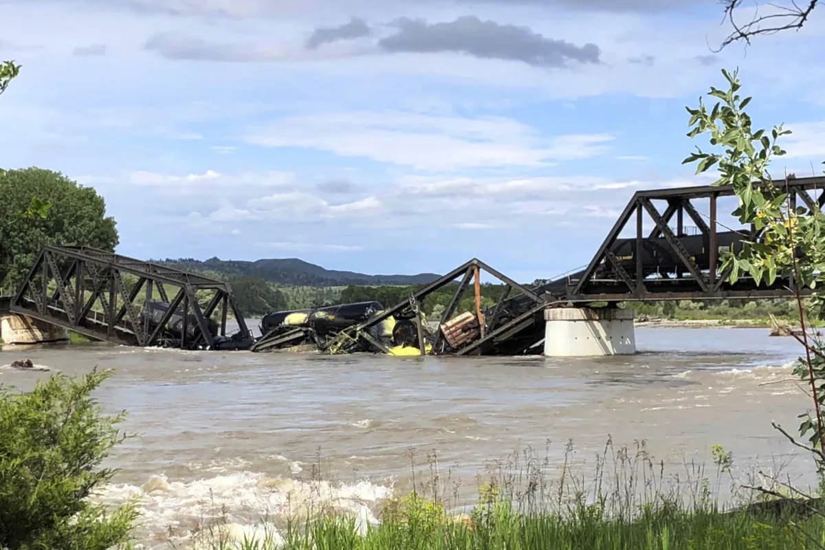 Several train cars are immersed in the Yellowstone River after a bridge collapse near Columbus, Mont., on June 24, 2023. (Matthew Brown/AP Photo)