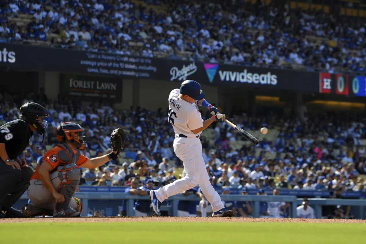 Los Angeles Dodgers' Will Smith, right, hits a solo home run in front of Houston Astros catcher Yainer Diaz, center, and home plate umpire Manny Gonzalez during the first inning of a baseball game in Los Angeles on June 24, 2023. (Mark J. Terrill/AP Photo)