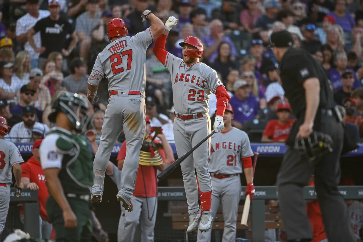 Mike Trout (27) of the Los Angeles Angels celebrates with Brandon Drury (23) after hitting a third inning solo home-run in a game against the Colorado Rockies at Coors Field in Denver on June 24, 2023. (Dustin Bradford/Getty Images)