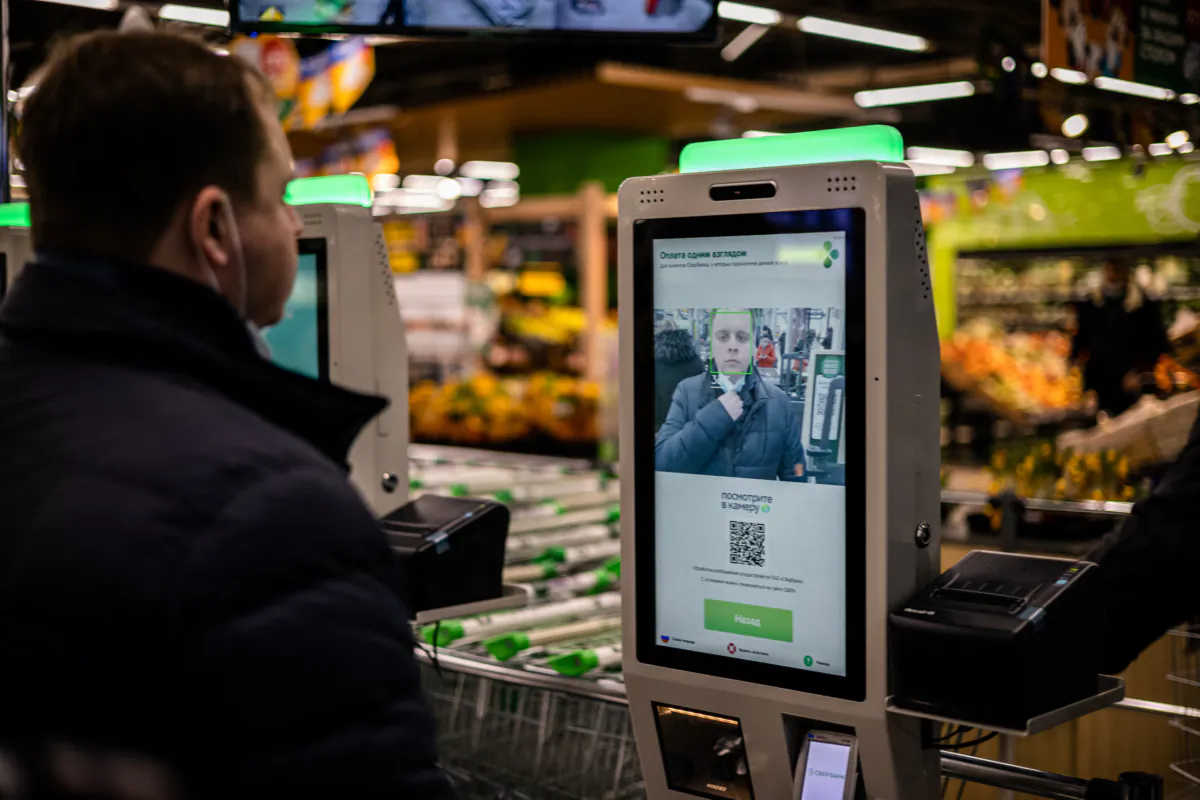 An X5 group representative demonstrates a facial recognition payment system at a self-checkout machine in in Moscow, Russia, on March 9, 2021. (Dimitar Dilkoff/AFP via Getty Images)