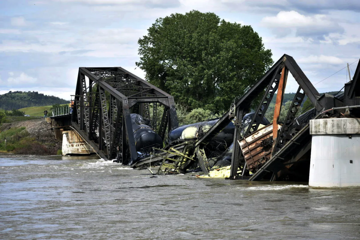 Several train cars are immersed in the Yellowstone River after a bridge collapse near Columbus, Mont., on June 24, 2023. (Matthew Brown/AP Photo)