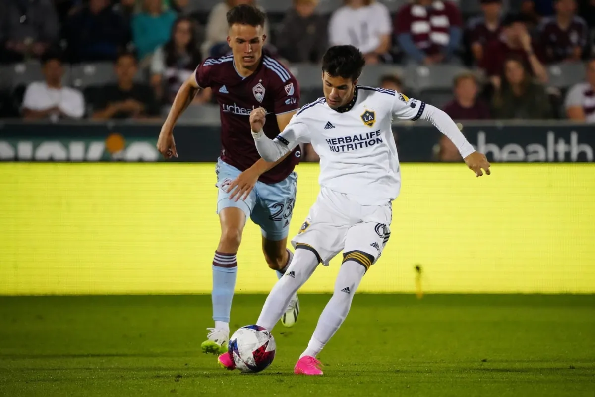 Los Angeles Galaxy midfielder Riqui Puig (6) controls the ball against Colorado Rapids midfielder Cole Bassett (23) during the second half at Dick's Sporting Goods Park in Commerce City, Col., on Jun 24, 2023. (Ron Chenoy/USA TODAY Sports via Field Level Media)
