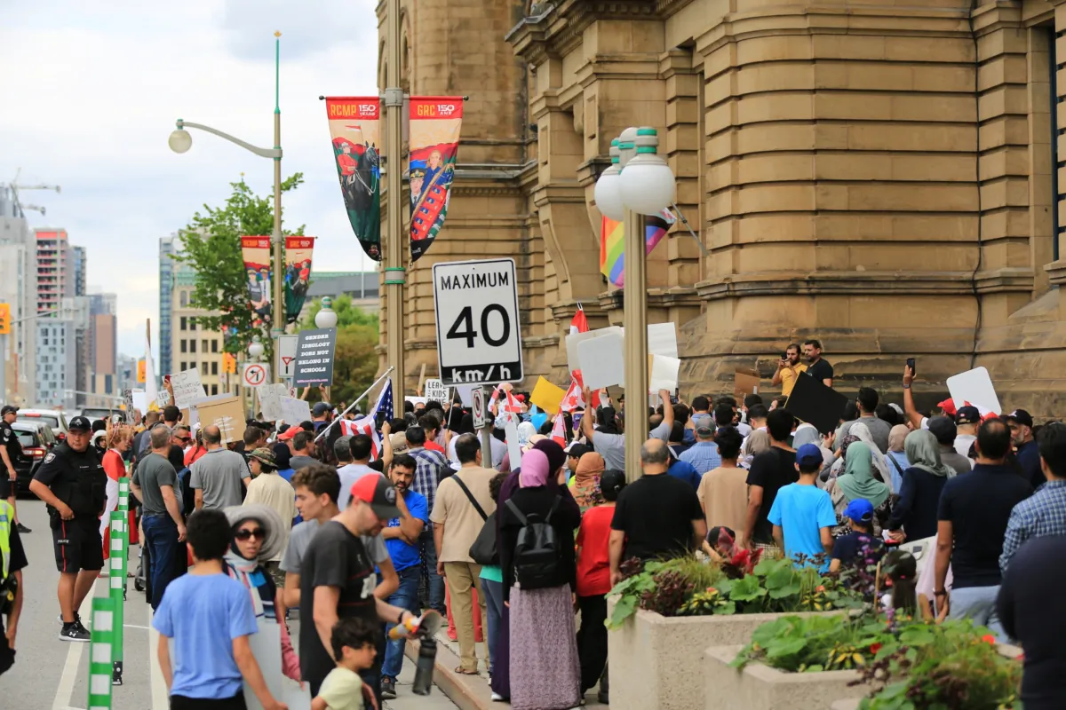 A large crowd of protesters gathers outside Prime Minister Justin Trudeau's office to protest teachings about gender ideology in schools, in Ottawa on June 24, 2023. (Jonathan Ren/The Epoch Times) 