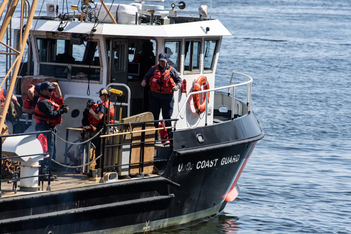 Crews work on Coast Guard vessels at Coast Guard Base Boston in Boston on June 21, 2023. (Joseph Prezioso/AFP via Getty Images)