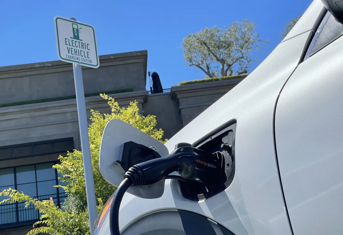 An electric car charges at a mall parking lot in Corte Madera, Calif., on June 27, 2022. (Photo by Justin Sullivan/Getty Images)
