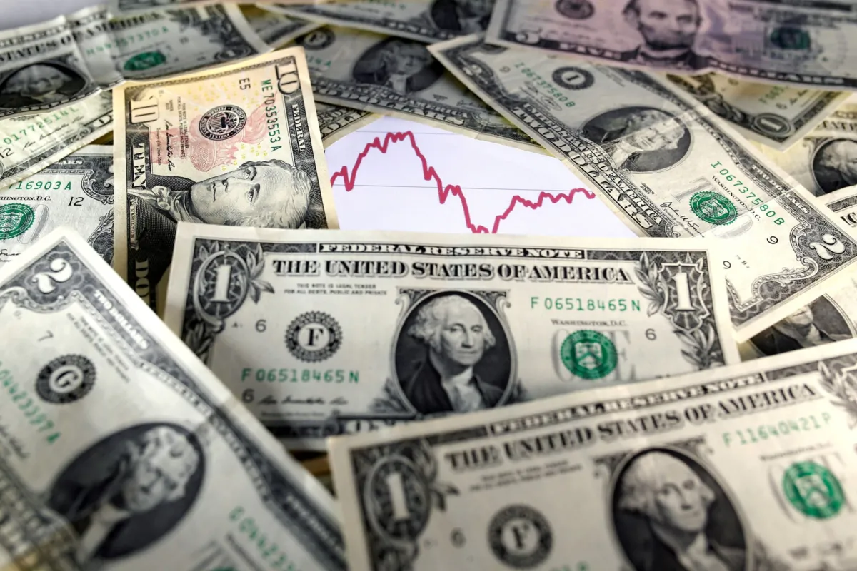 U.S. dollar notes are seen in front of a stock graph in this Nov. 7, 2016 picture illustration. (Dado Ruvic/Illustration/Reuters)