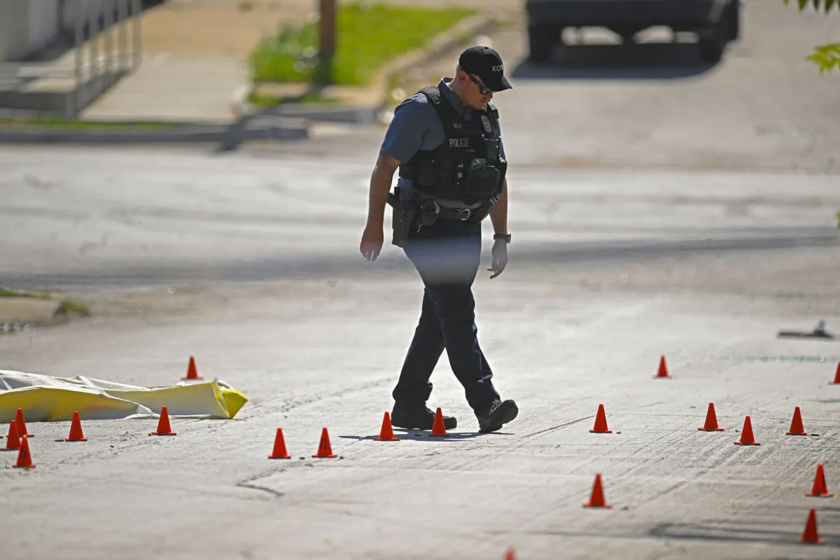 Evidence markers filled the street as police were investigating the scene after several people died and others were injured following a shooting near 57th Street and Prospect Avenue in Kansas City, Mo., on June 25, 2023. (Tammy Ljungblad/The Kansas City Star via AP)