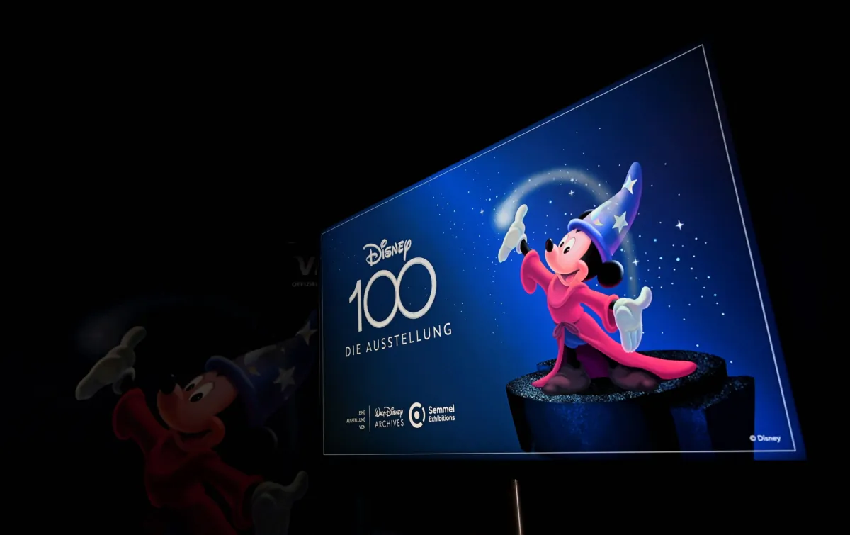 A screen shows the announcement of the "Disney 100 - The Exhibition" show in the small Olympic hall in Munich on April 17, 2023. (Christof Stache/AFP via Getty Images)