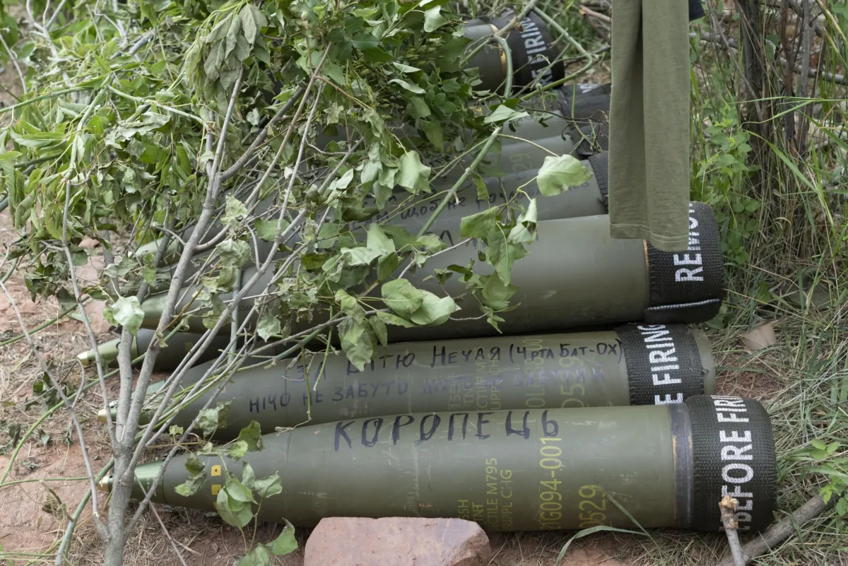 U.S.-supplied M777 howitzer shells lie on the ground to fire at Russian positions in Ukraine's eastern Donbas region on June 18, 2022. (Efrem Lukatsky/AP Photo)