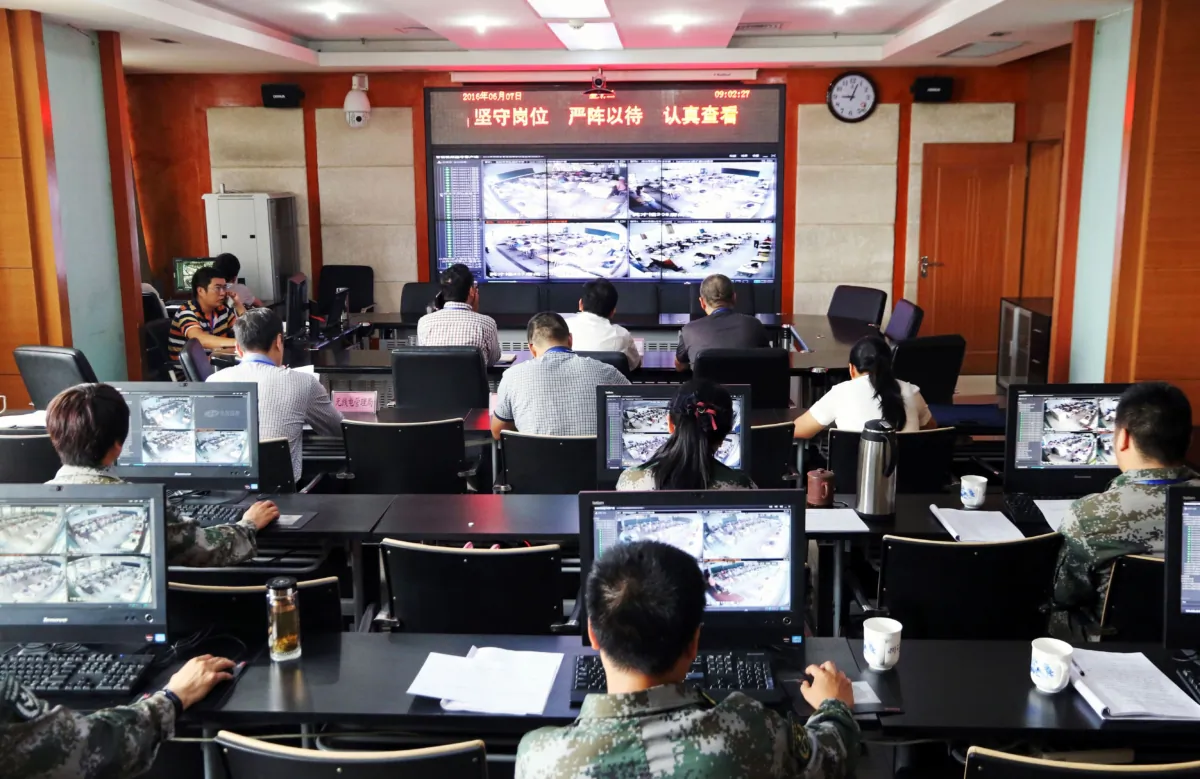 Staff members monitoring students during their college entrance exam in Zhengzhou, central China's Henan province, on June 7, 2016. (STR/AFP via Getty Images)