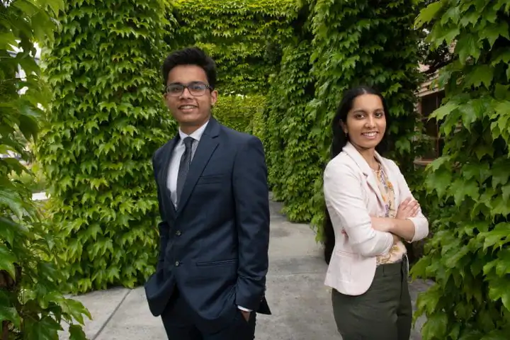 Pratyush Muthukumar (L) poses with his sister Karishma Muthukumar at the University of California—Irvine in Irvine, Calif., on May 15, 2023. (Courtesy of Steve Zylius at University of California–Irvine)