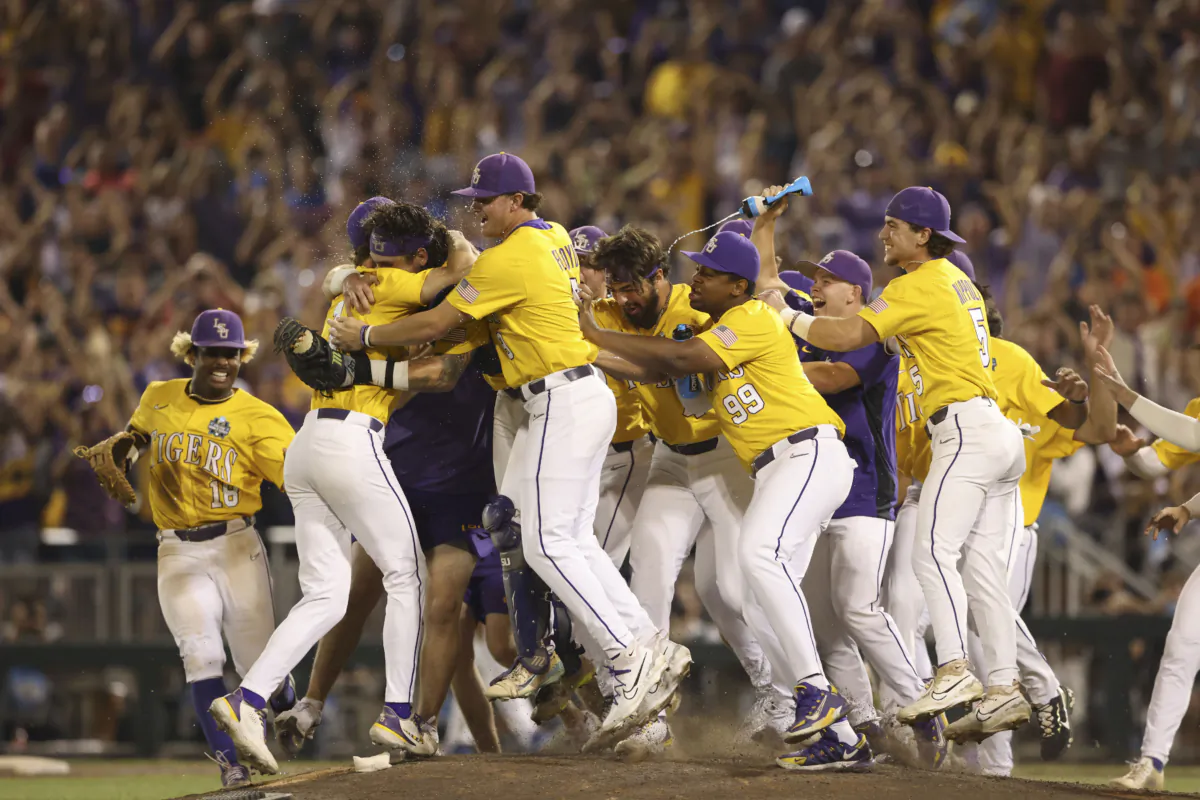 LSU closer Gavin Guidry, left, hugs teammates after defeating Florida in Game 3 of the NCAA College World Series baseball finals in Omaha, Neb., on June 26, 2023. (Rebecca S. Gratz/AP Photo)
