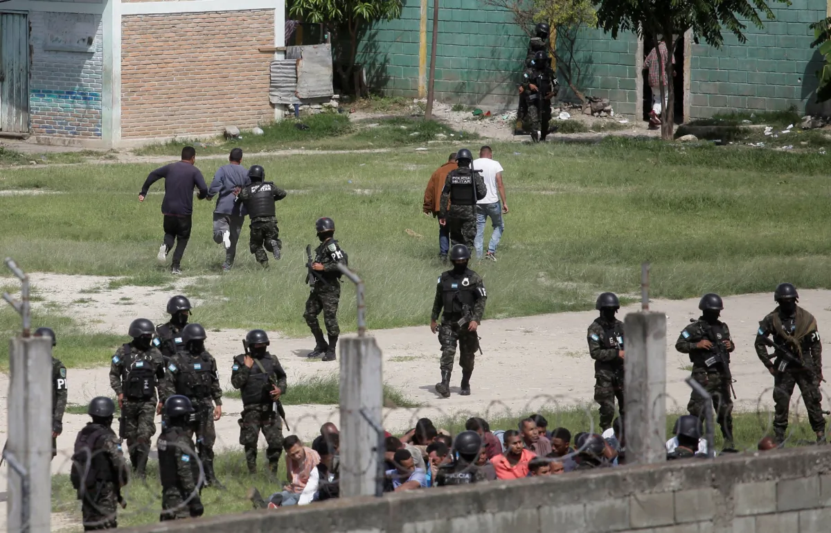 Members of the Military Police of Public Order remove inmates from the yard at Tamara prison after the Honduras Armed Forces took over the control of the prisons nationwide as part of the "Fe y Esperanza" operation, on the outskirts of Tegucigalpa, Honduras, on June 26, 2023. (Fredy Rodriguez/Reuters)