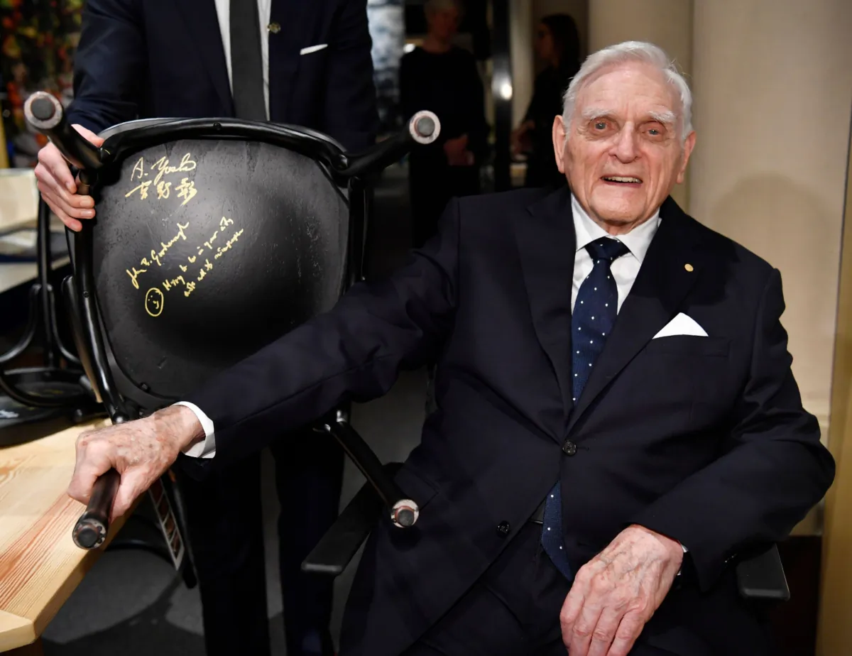 American scientist John Bannister Goodenough, Nobel Prize laureate in Chemistry 2019, poses signing a chair at the Nobel Museum in Stockholm, Sweden, on Dec. 6, 2019. (Henrik Montgomery/TT News Agency/AFP via Getty Images)