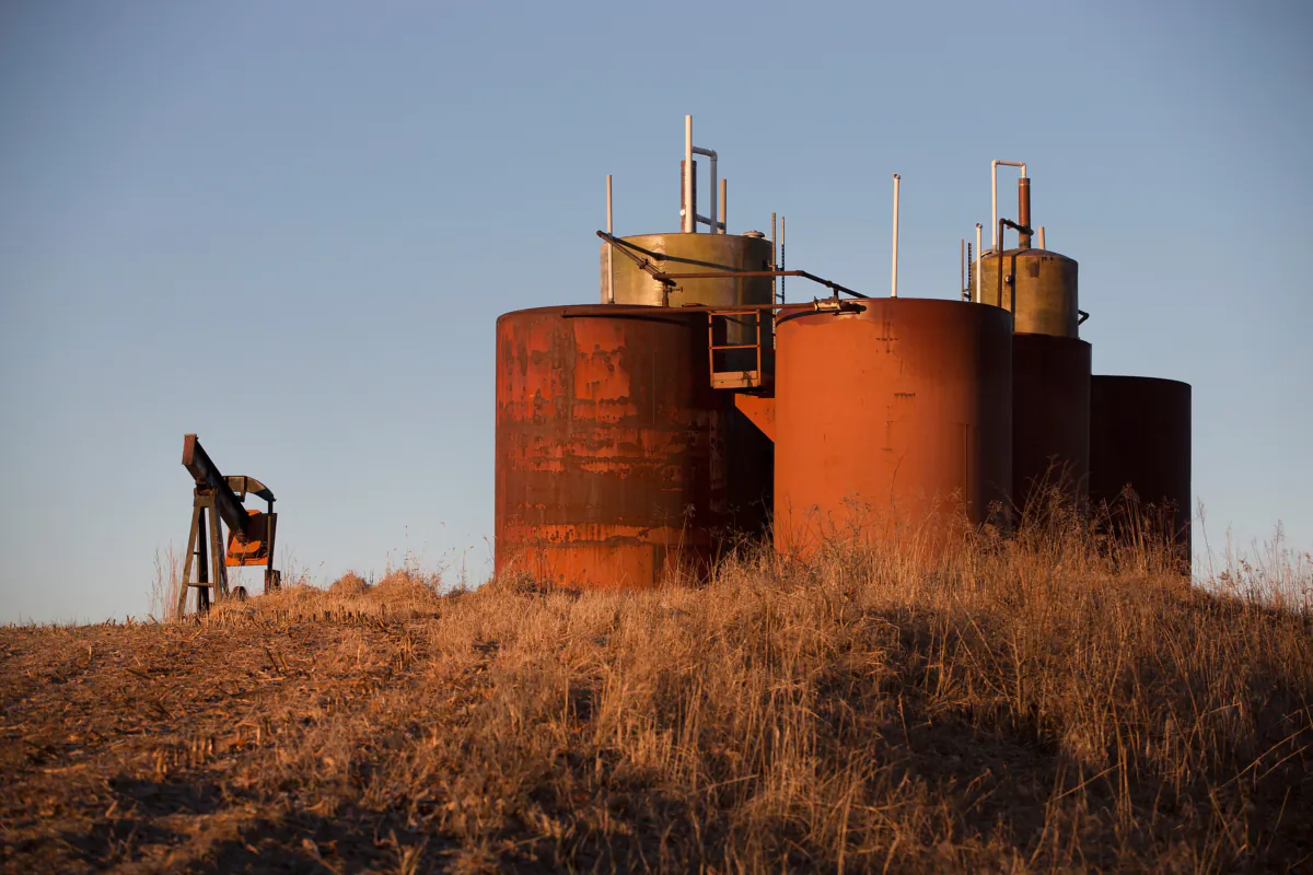 An idled pump jack and a tank battery in a file photo. (Scott Olson/Getty Images)