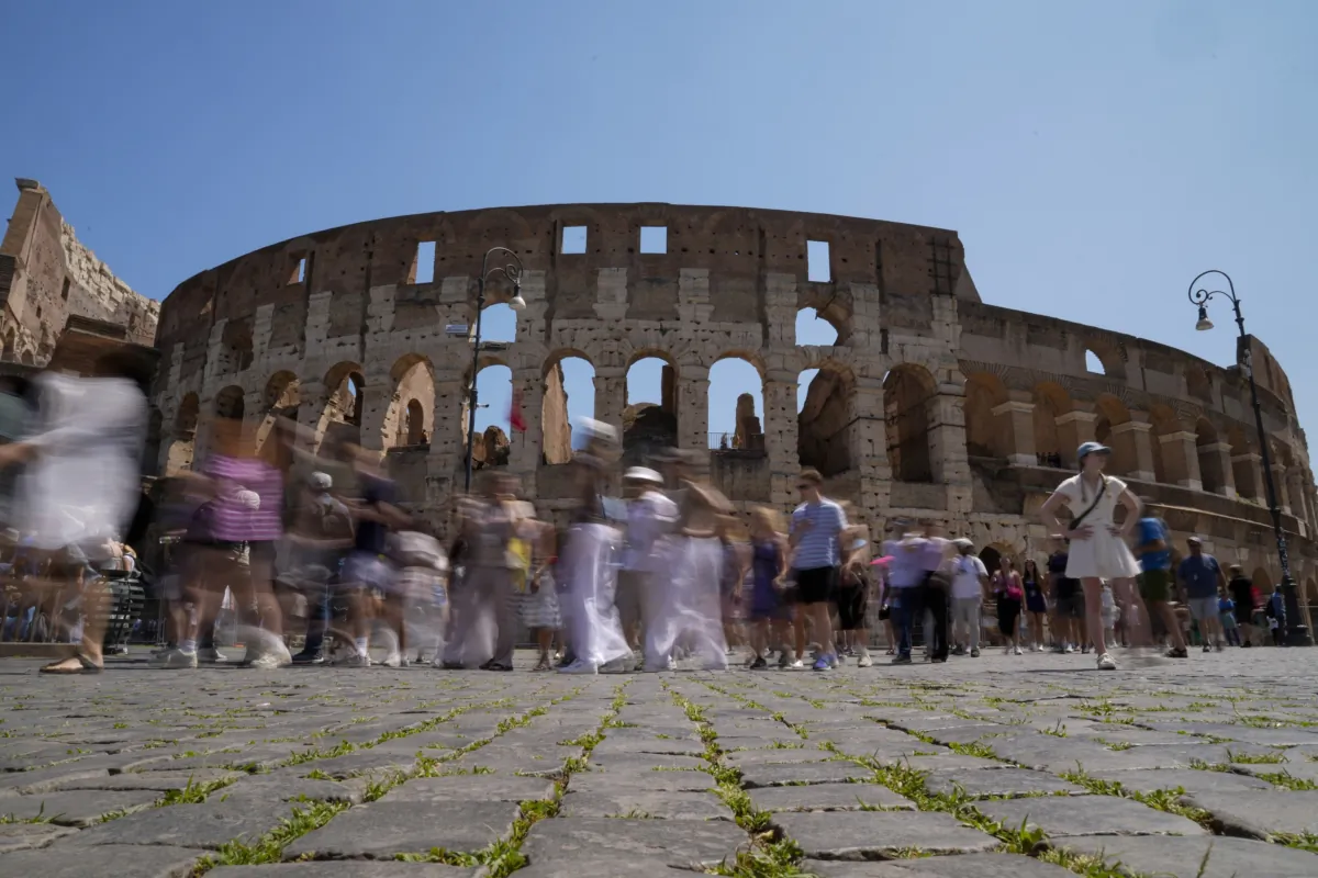 Visitors walk past the Colosseum in Rome, on June 27, 2023. (Andrew Medichini/AP Photo)