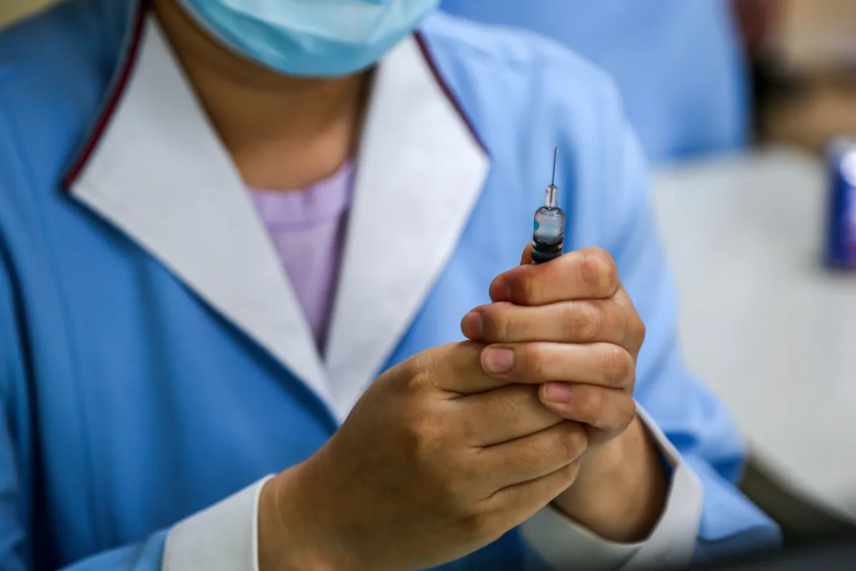 A nurse prepares a pneumococcal vaccine in a June 1, 2020, file image. (STR/AFP via Getty Images)