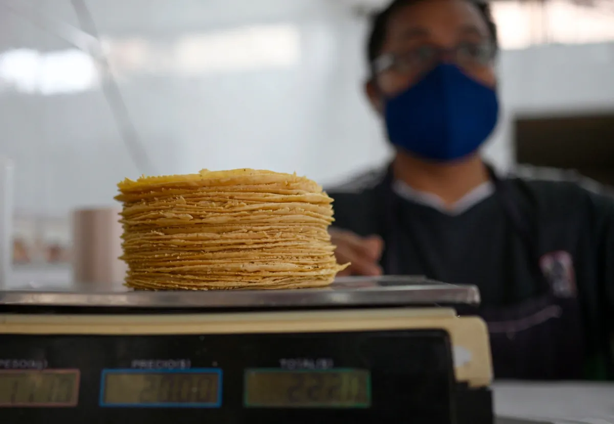 A worker weighs tortillas at a tortilla factory in Mexico City, on Sept. 21, 2022. (Alfredo Estrella/AFP via Getty Images)