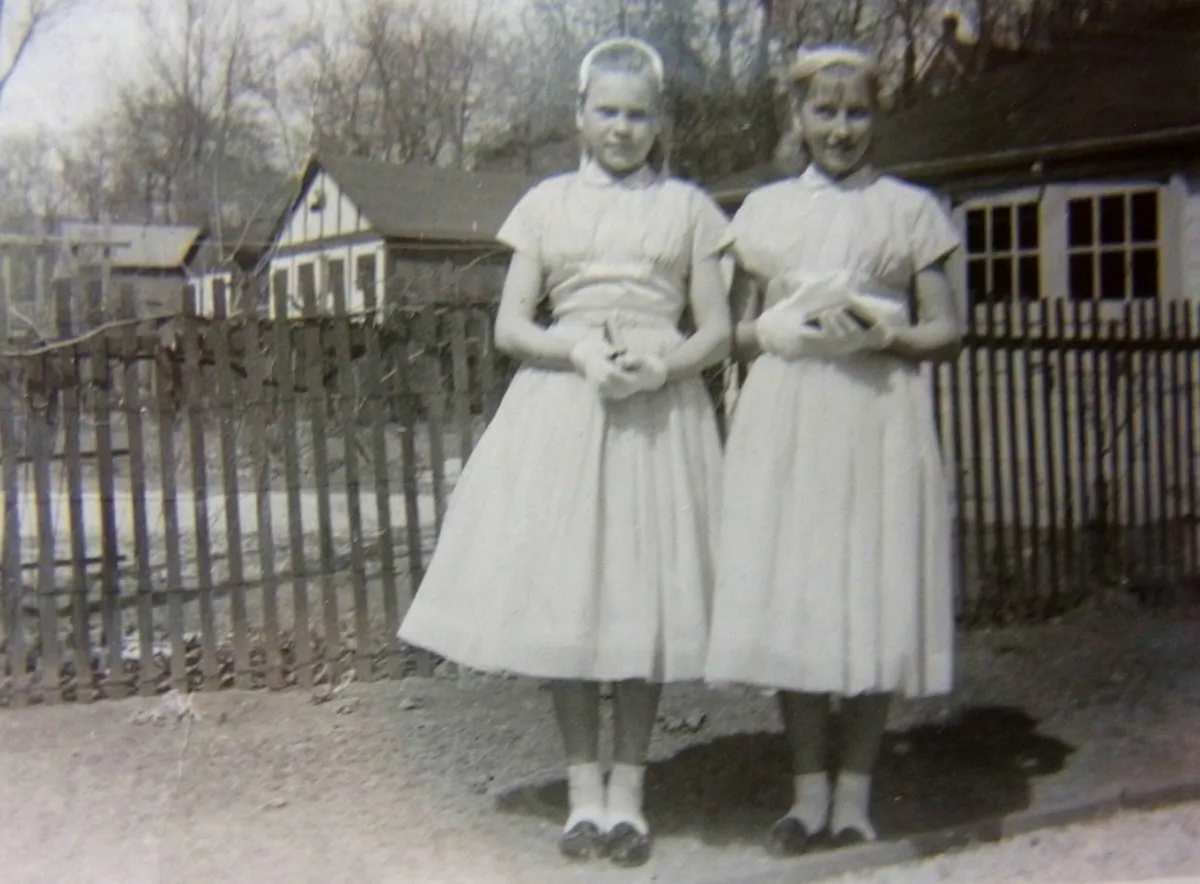 Karla Poewe (R) poses with her sister on their confirmation day in front of a church in Toronto in 1956. (Courtesy of Karla Poewe)