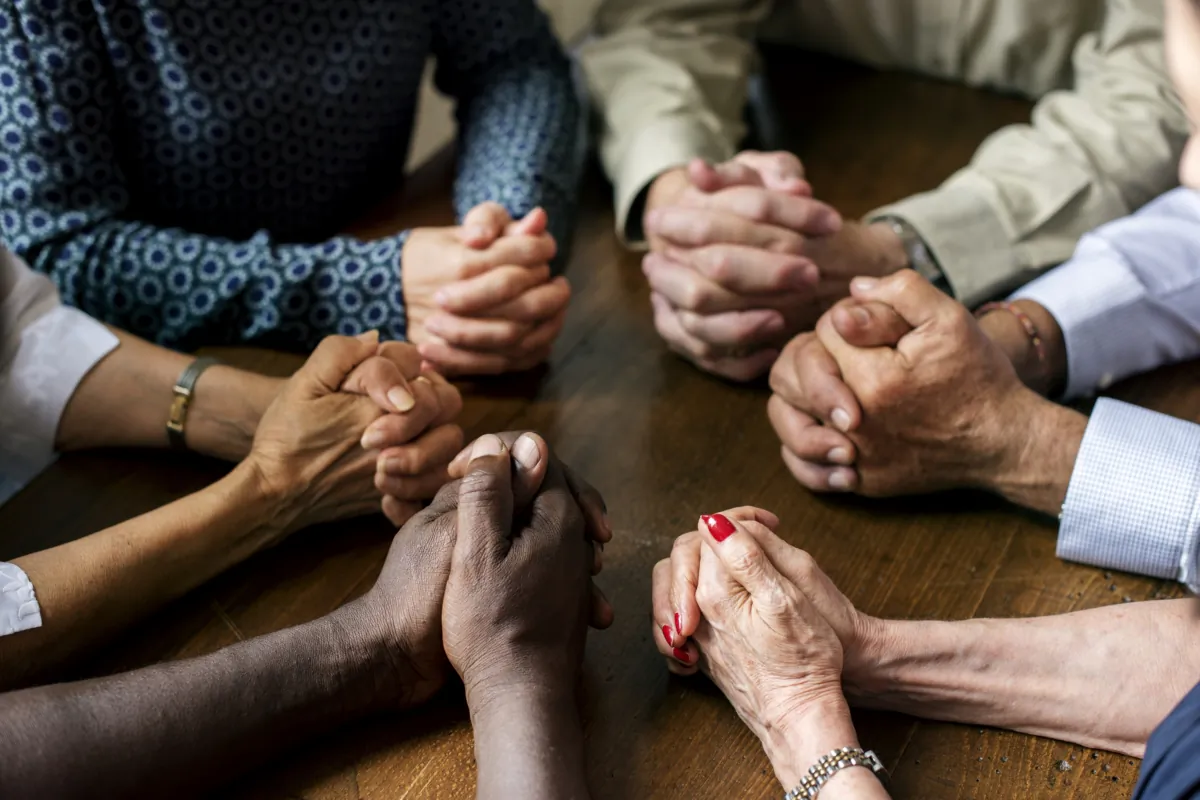 People hold their hands together. (Shutterstock)