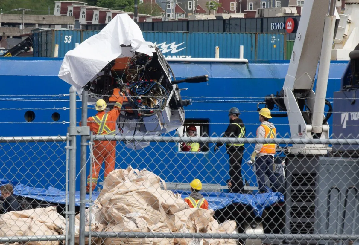 Debris from the Titan submersible, recovered from the ocean floor near the wreck of the Titanic, is unloaded from the ship Horizon Arctic at the Canadian Coast Guard pier in St. John’s on June 28, 2023. (Paul Daly/The Canadian Press)