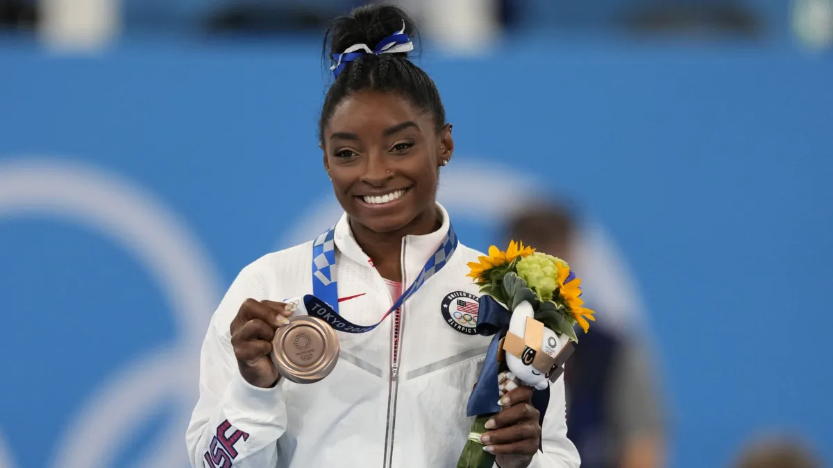 U.S. gymnast Simone Biles poses with her bronze medal for the artistic gymnastics women's balance beam apparatus at the 2020 Summer Olympics in Tokyo on Aug. 3, 2021. (Jae C. Hong/AP Photo)