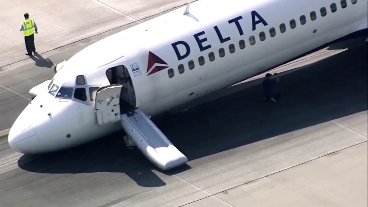 A Delta plane lands without its landing gear at the Charlotte Douglas International Airport in Charlotte, N.C., on June 28, 2023. (WSOC-TV via AP)