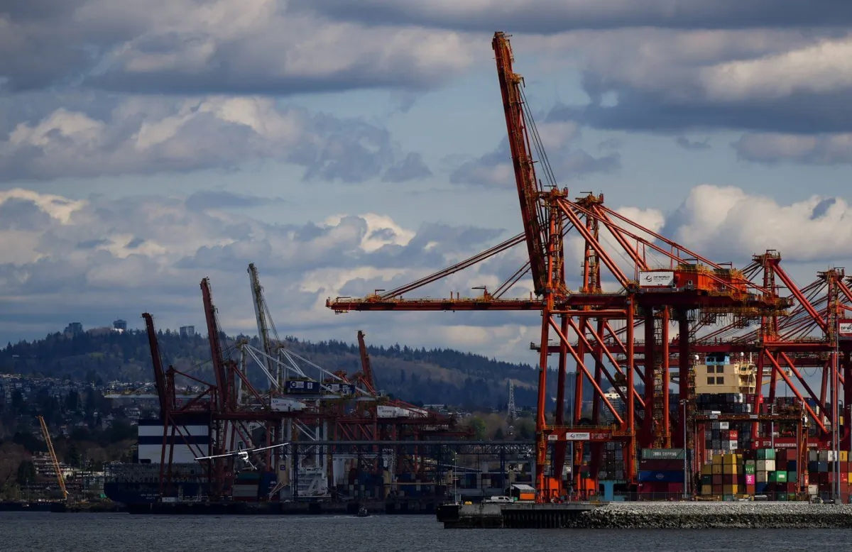 A seaplane prepares to land on the harbour as gantry cranes used to load and unload cargo containers are seen at port, in Vancouver, on April 25, 2023. (The Canadian Press/Darryl Dyck)
