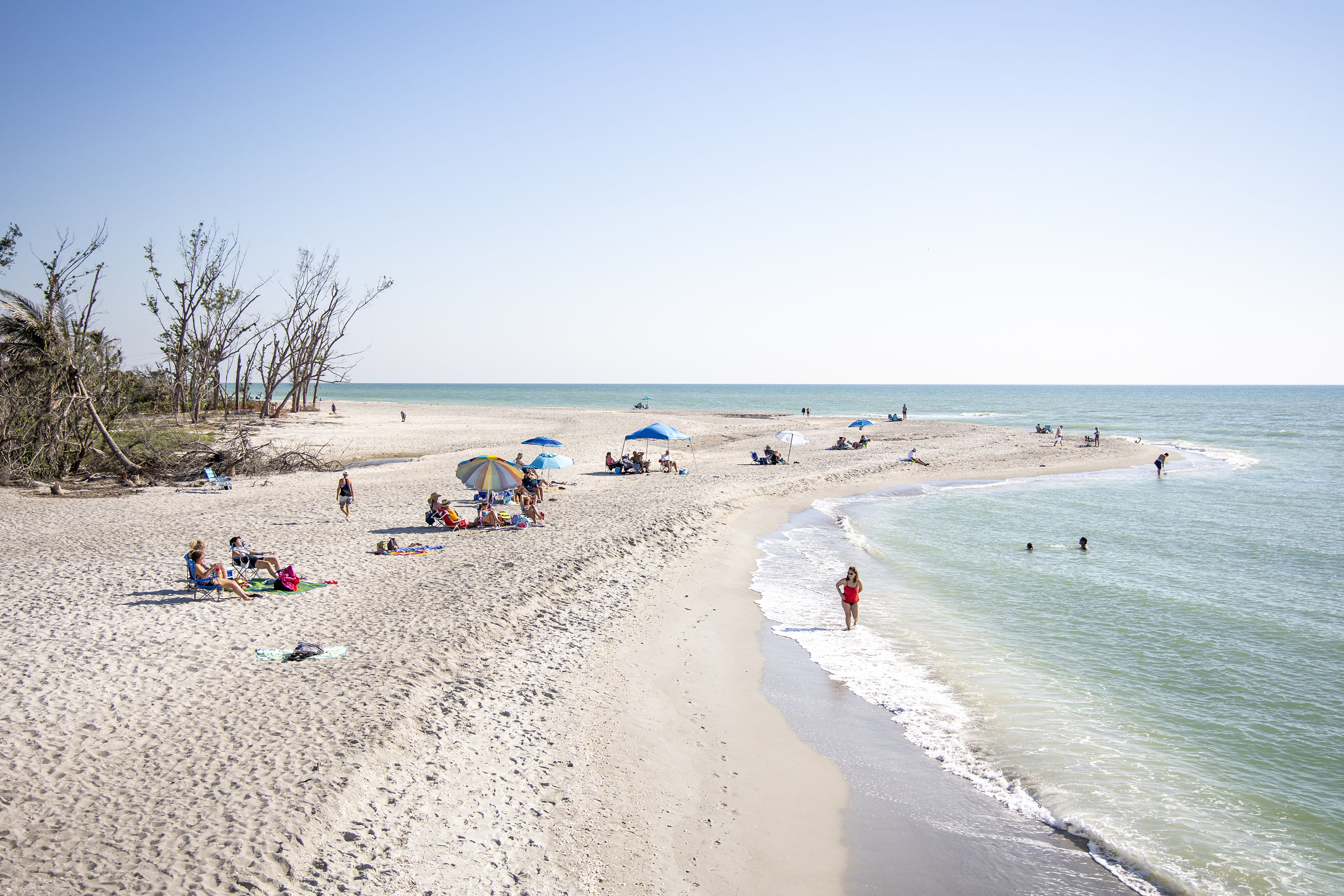 Beachgoers take in some sun at Blind Pass Beach on Sanibel Island on March 1, 2023.