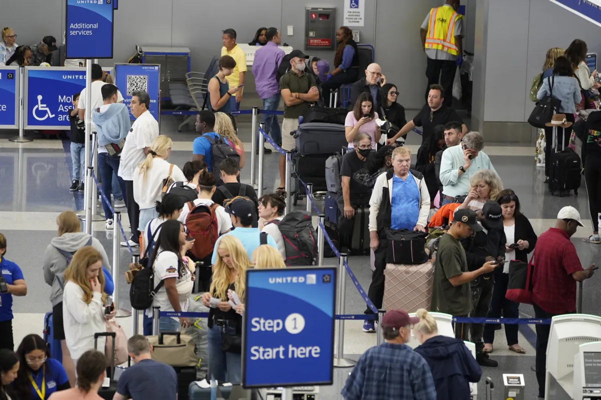 Travelers wait at the departure area check-in at the United Airlines terminal at Los Angeles International Airport on June 28, 2023. (Damian Dovarganes/AP Photo)
