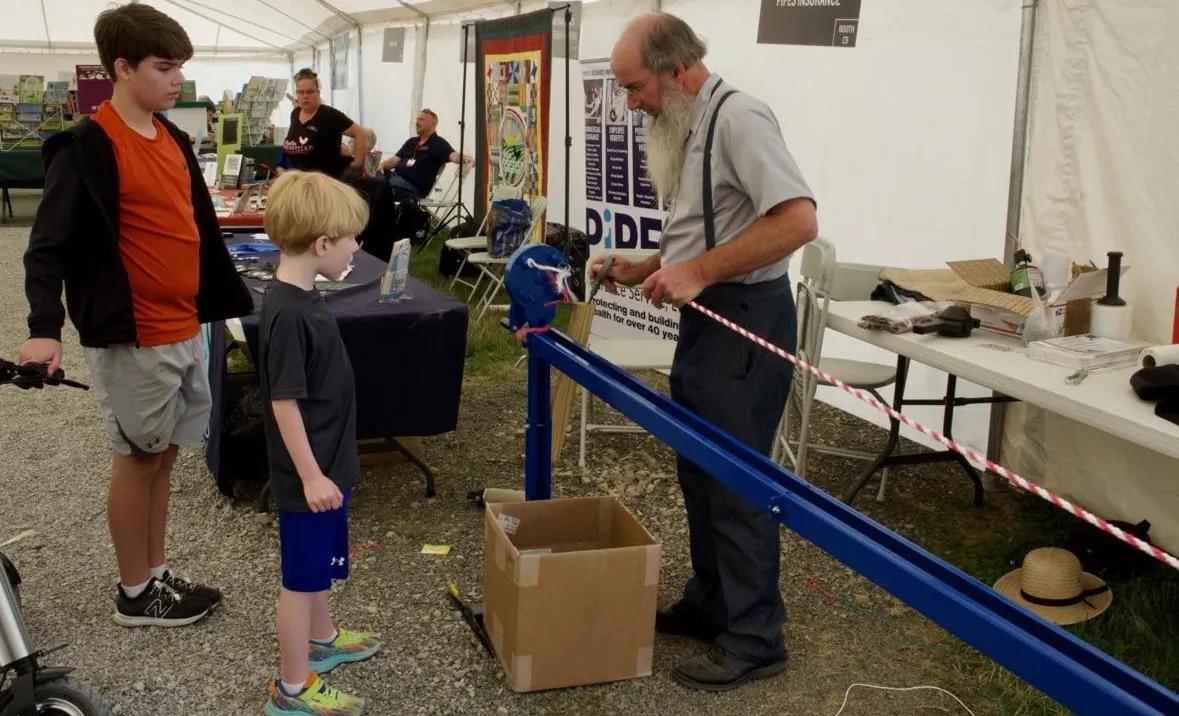 Levi Schlabach taught children the ropemaking process at the Food Independence Summit. (Courtesy of Everitt Townsend)