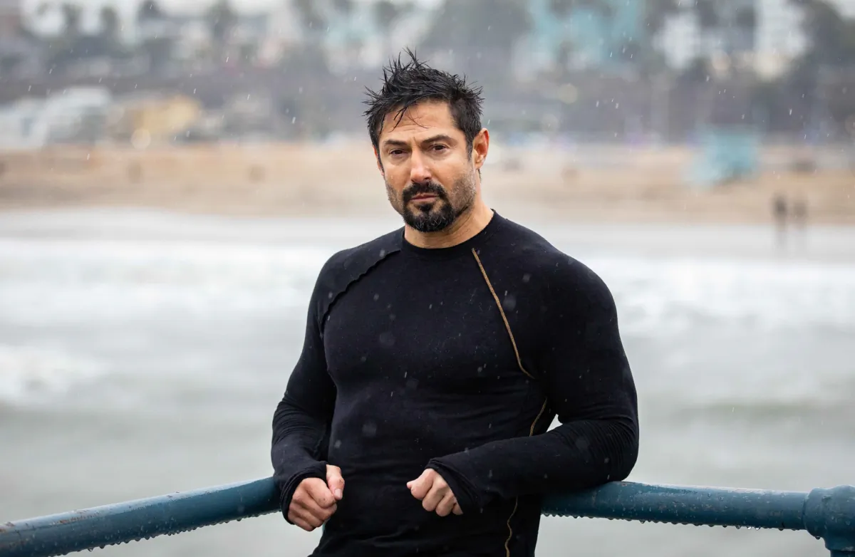 Rudy Reyes embraces stormy weather conditions in Santa Monica, Calif., on Jan. 14, 2023. (John Fredricks for American Essence)