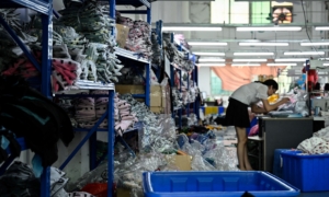 A worker makes clothes at a garment factory that supplies SHEIN, a