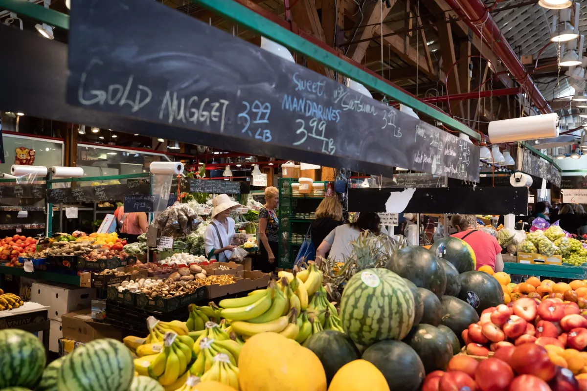 People shop for produce at the Granville Island Market in Vancouver on July 20, 2022. (The Canadian Press/Darryl Dyck)