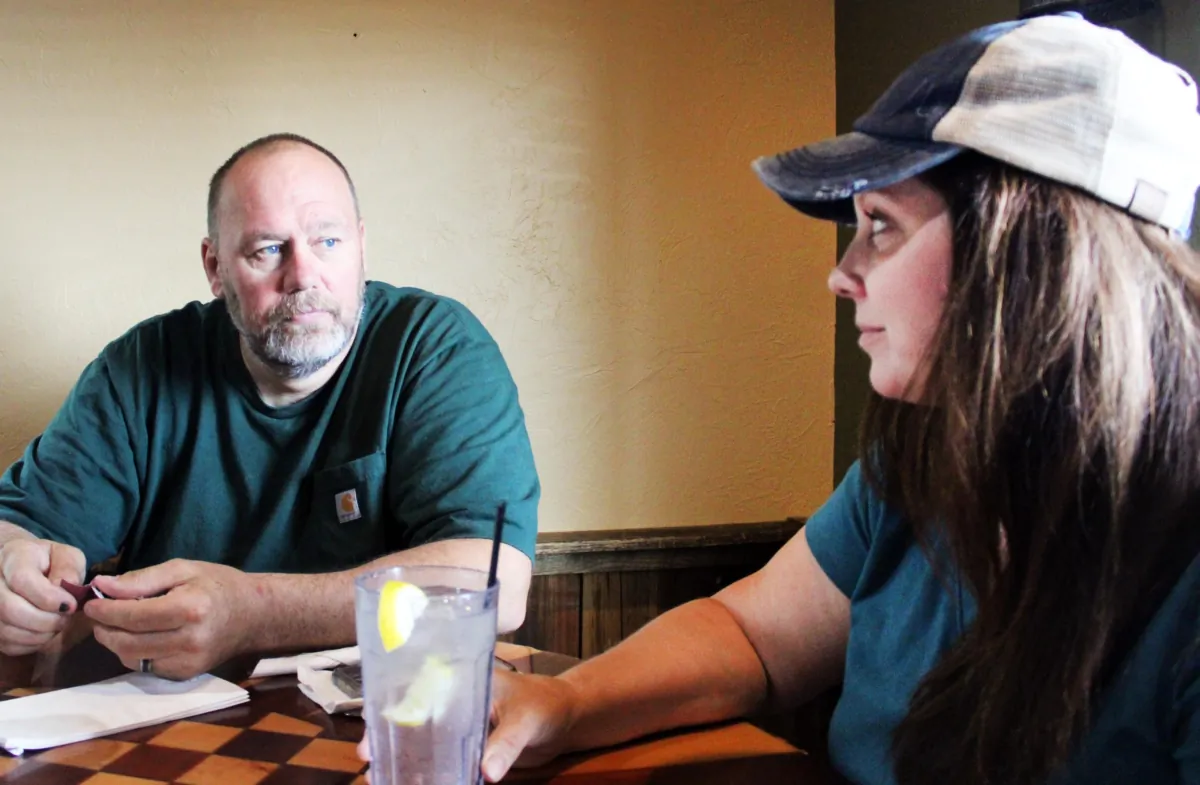 Darin Agnew (L) and his wife, Michelle, talk about losing their business, Searles on Fifth Avenue, in St. Cloud, Minn., before it was even opened in this June 22, 2023, photo. (Michael Clements/The Epoch Times)