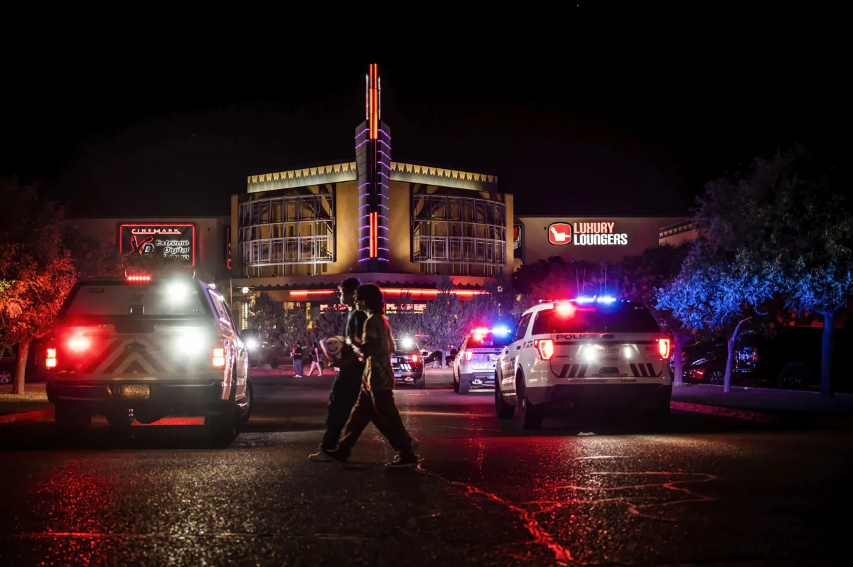 Movie-goers evacuate the Century Rio movie theater as officers respond to a shooting at the theater located at 4901 Pan American freeway in northeast Albuquerque, N.M., on June 25, 2023. (Chancey Bush/The Albuquerque Journal via AP)